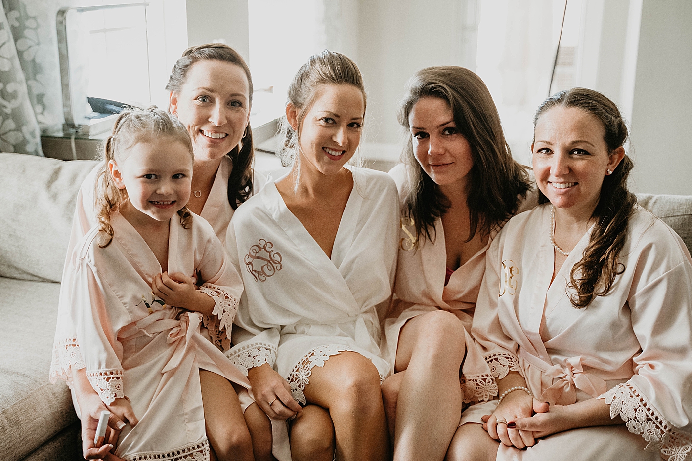 Bride and Bridesmaids getting ready in robes Out of the Blue Celebrations Wedding Photography captured by South Florida Wedding Photographer Krystal Capone Photography 