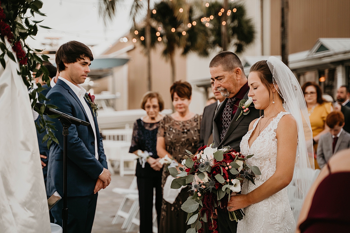 Groom looking at Bride during prayer Ceremony Out of the Blue Celebrations Wedding Photography captured by South Florida Wedding Photographer Krystal Capone Photography 