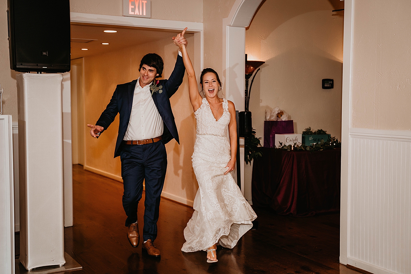 Bride and Groom having a fun entrance into Reception Out of the Blue Celebrations Wedding Photography captured by South Florida Wedding Photographer Krystal Capone Photography 