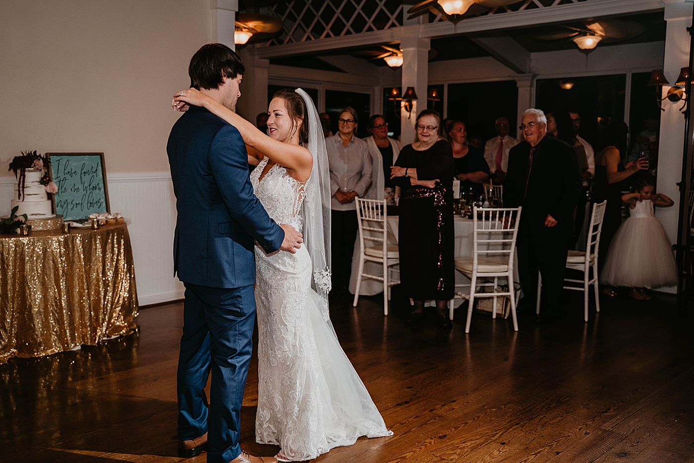 Bride and Groom dancing with audience standing and cake table Out of the Blue Celebrations Wedding Photography captured by South Florida Wedding Photographer Krystal Capone Photography 