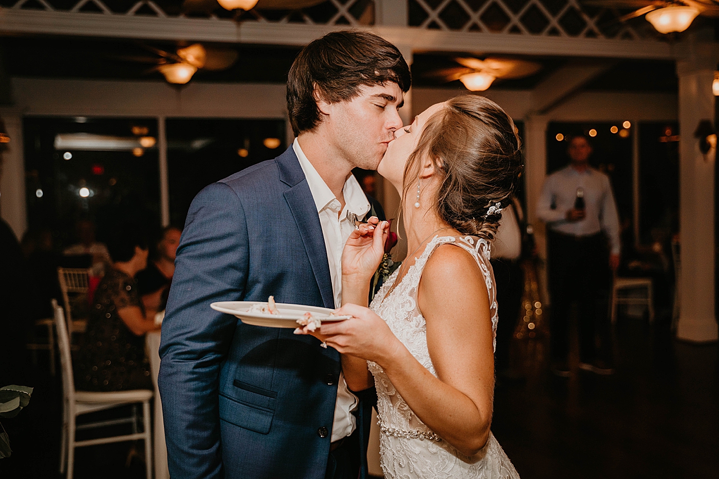 Bride and Groom kissing after Cake Cutting Out of the Blue Celebrations Wedding Photography captured by South Florida Wedding Photographer Krystal Capone Photography 