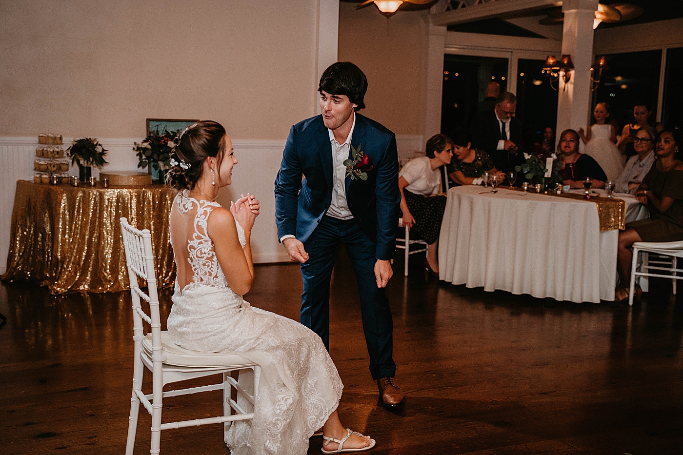 Groom dancing for garter Out of the Blue Celebrations Wedding Photography captured by South Florida Wedding Photographer Krystal Capone Photography 
