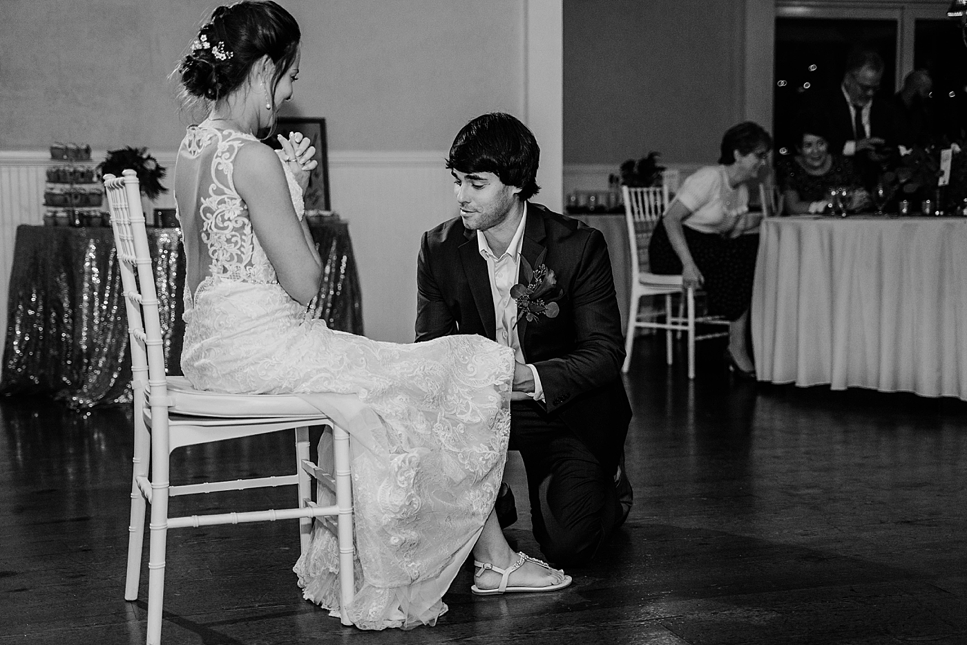 B&W Groom getting garter Out of the Blue Celebrations Wedding Photography captured by South Florida Wedding Photographer Krystal Capone Photography 