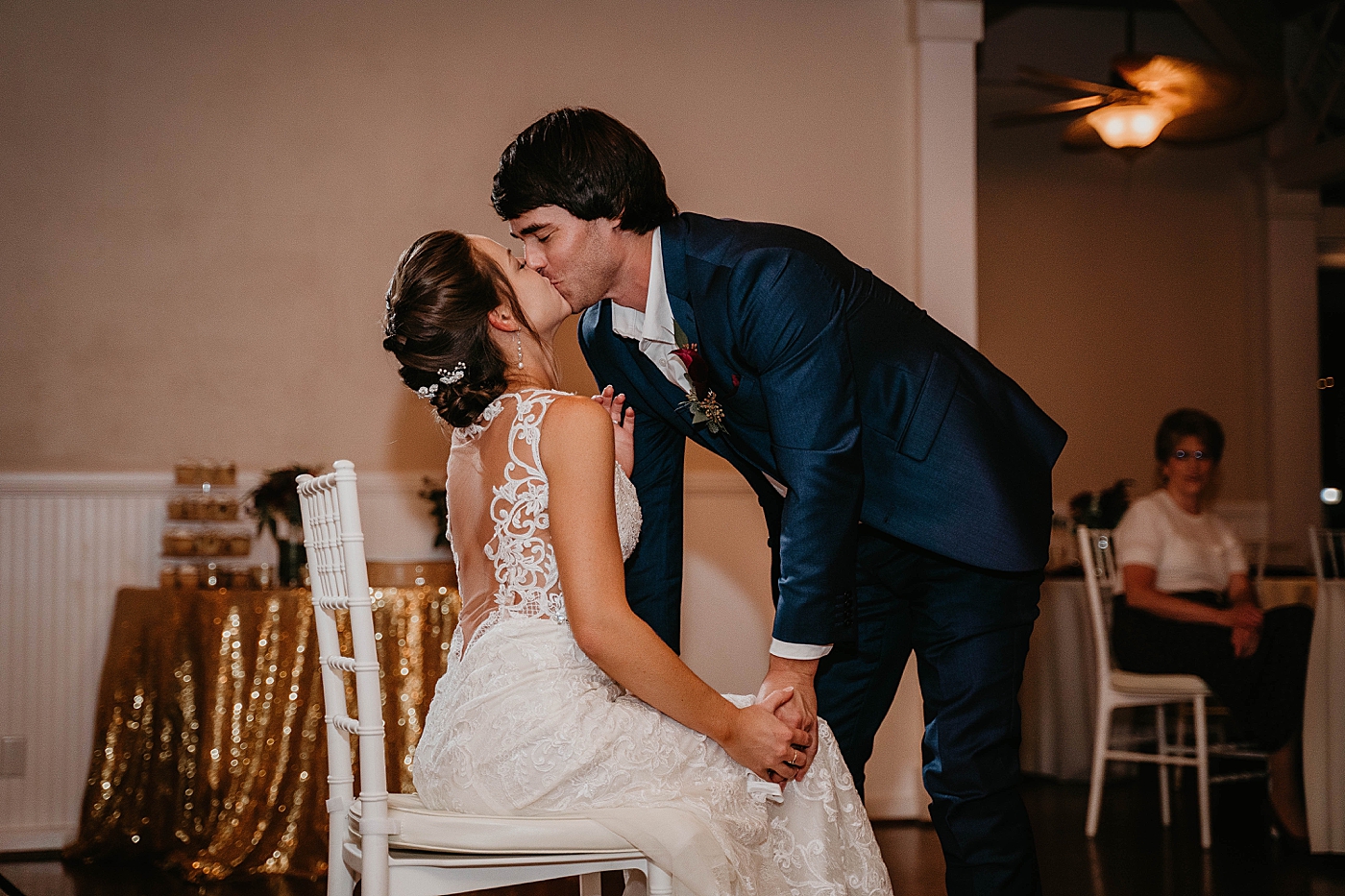 Bride and Groom kissing after getting garter Out of the Blue Celebrations Wedding Photography captured by South Florida Wedding Photographer Krystal Capone Photography 