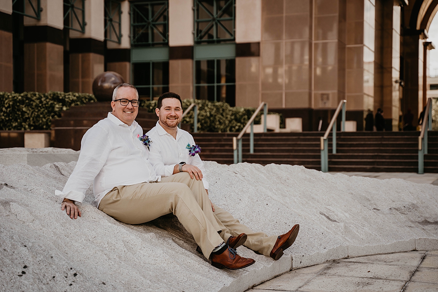 Grooms sitting together with purple boutonnieres Palm Beach Elopement Photography captured by South Florida Photographer Krystal Capone Photography 