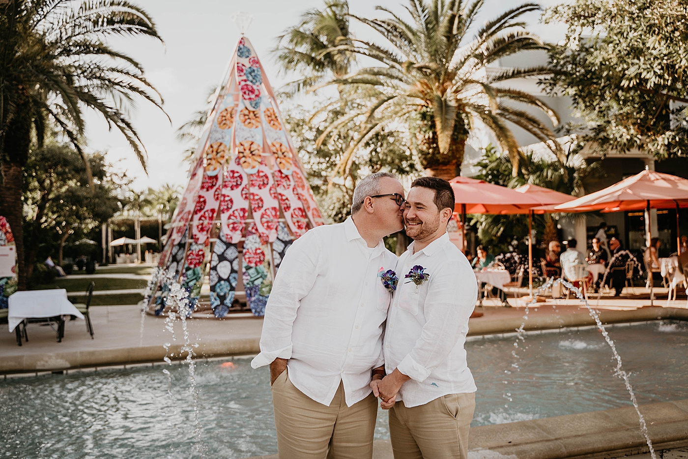 Groom kissing Groom by water fountain Palm Beach Elopement Photography captured by South Florida Photographer Krystal Capone Photography 