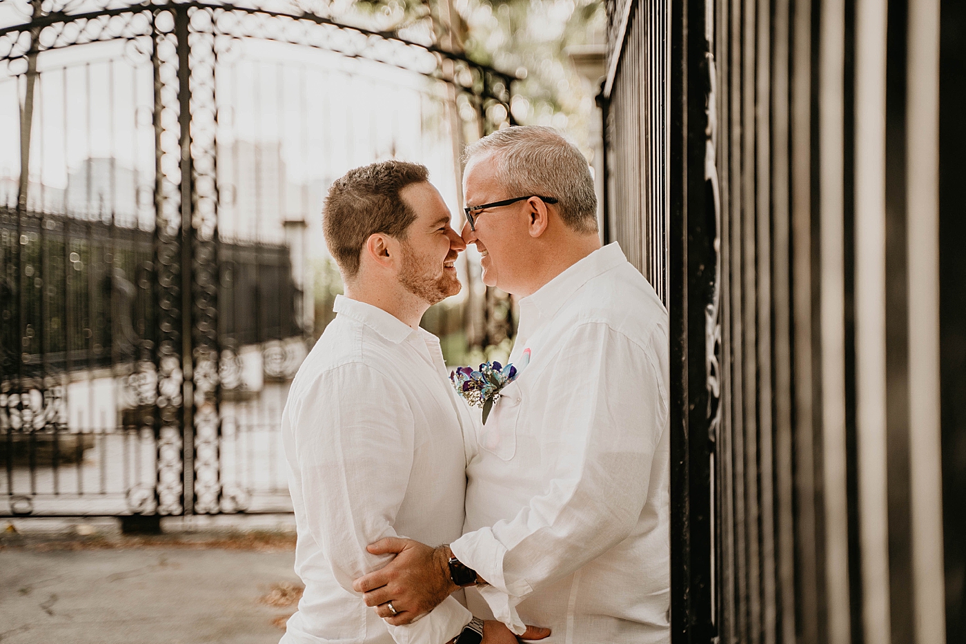 Couple nuzzling in front of gate Palm Beach Elopement Photography captured by South Florida Photographer Krystal Capone Photography 