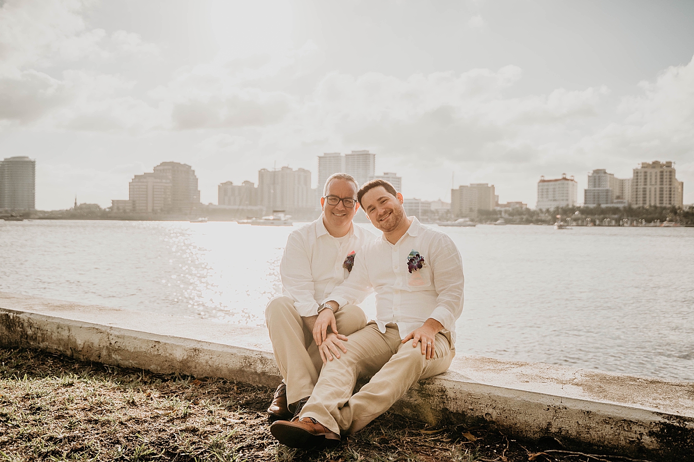 Couple sitting together by water side Palm Beach Elopement Photography captured by South Florida Photographer Krystal Capone Photography 