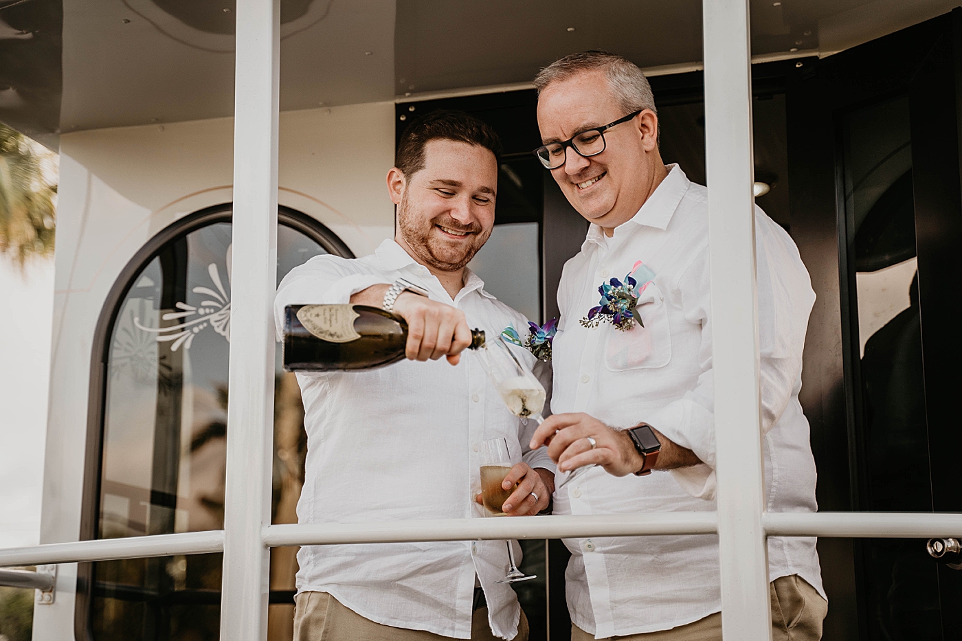 Couple pouring Champaign on Molly's Trolley Palm Beach Elopement Photography captured by South Florida Photographer Krystal Capone Photography 