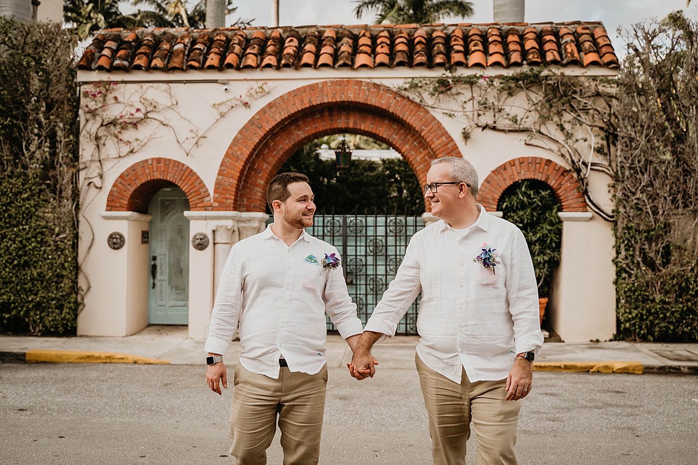 Grooms holding hands and walking Palm Beach Elopement Photography captured by South Florida Photographer Krystal Capone Photography 