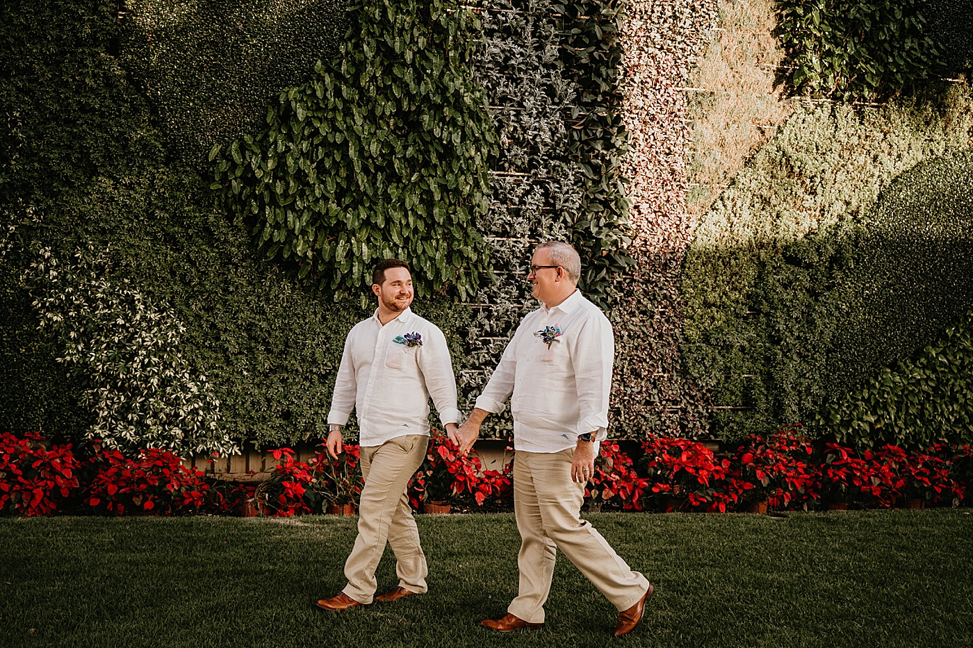 Grooms holding hands walking through garden Palm Beach Elopement Photography captured by South Florida Photographer Krystal Capone Photography 