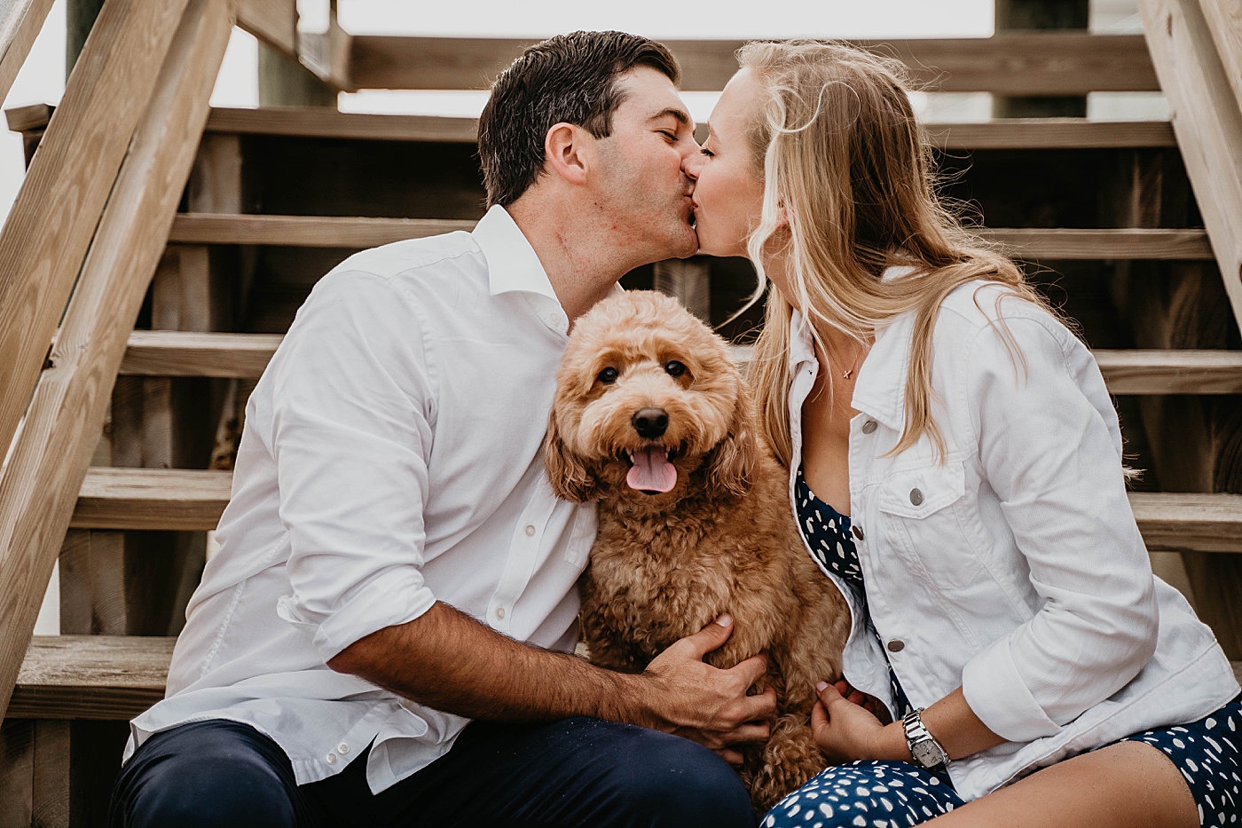 Couple kissing with dog in between them Palm Beach Engagement Photography captured by South Florida Engagement Photographer Krystal Capone Photography 