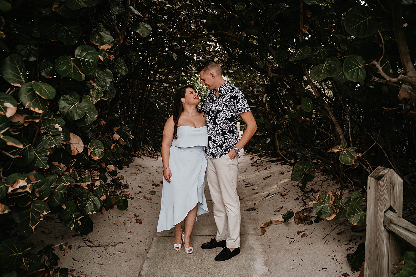 Couple holding each other and looking at each other on sandy path South Florida Beach Photography captured by Krystal Capone Photography