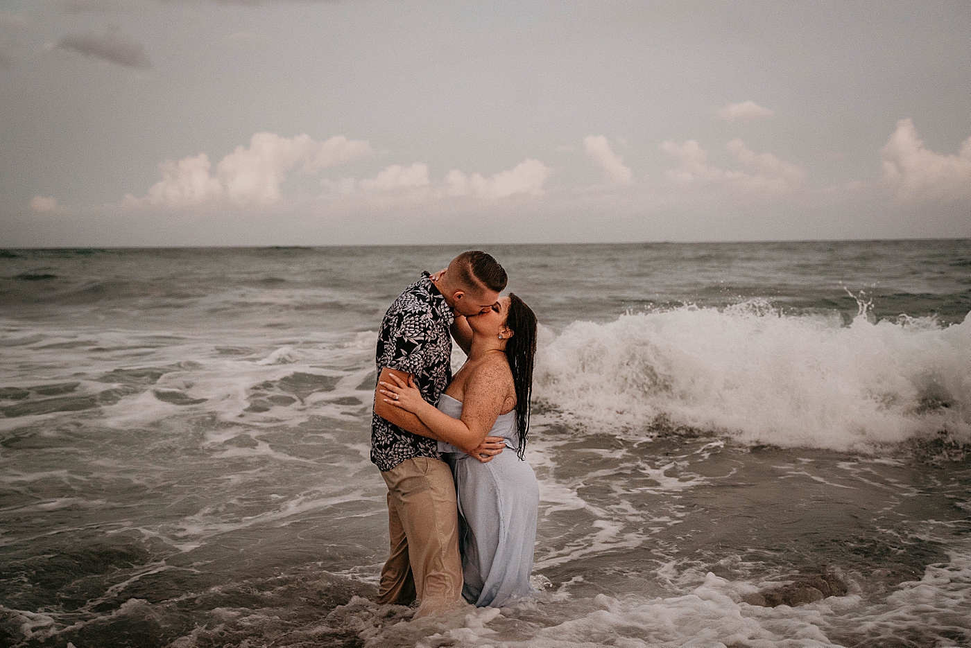 Couple standing in the ocean soaked and kissing South Florida Beach Photography captured by Krystal Capone Photography