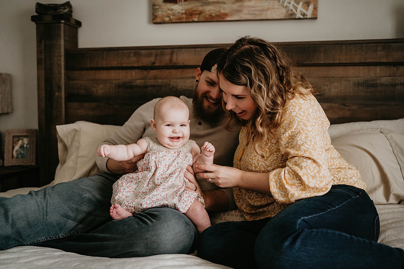 Laughing Baby of Dad's lap with Mom playing with baby At Home South Florida Family Photography captured by South Florida Family Photographer Krystal Capone Photography 