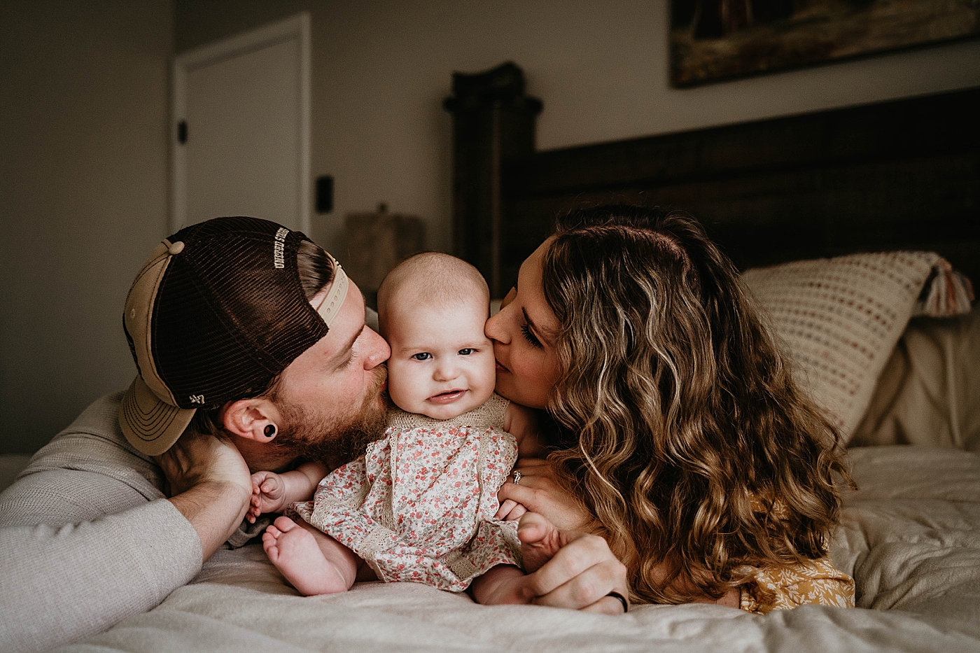 Mom and Dad kissing baby on each cheek At Home South Florida Family Photography captured by South Florida Family Photographer Krystal Capone Photography 