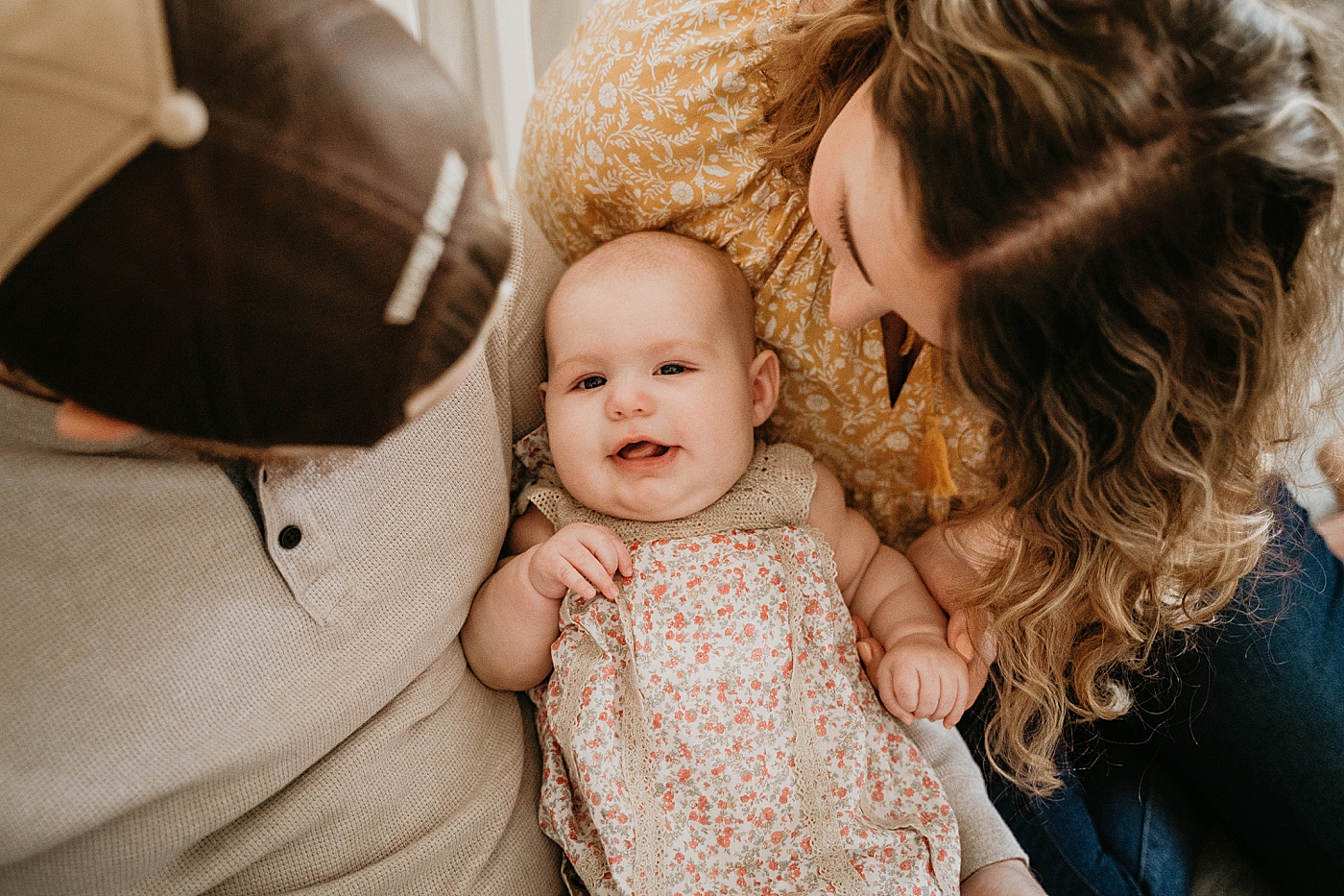 Baby laying down with Mom and Dad At Home South Florida Family Photography captured by South Florida Family Photographer Krystal Capone Photography 