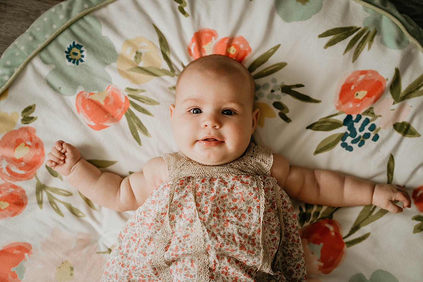 Baby laying down on floral bed At Home South Florida Family Photography captured by South Florida Family Photographer Krystal Capone Photography 