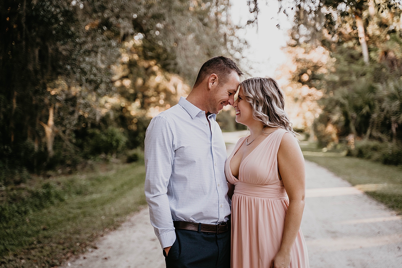 Couple nuzzling on path Riverbend Park Engagement Photography captured by South Florida Engagement Photographer Krystal Capone Photography
