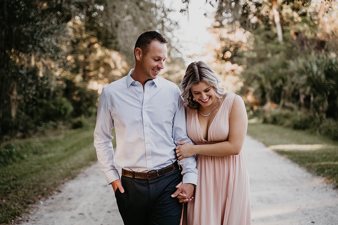 Couple laughing and having fun during walk Riverbend Park Engagement Photography captured by South Florida Engagement Photographer Krystal Capone Photography