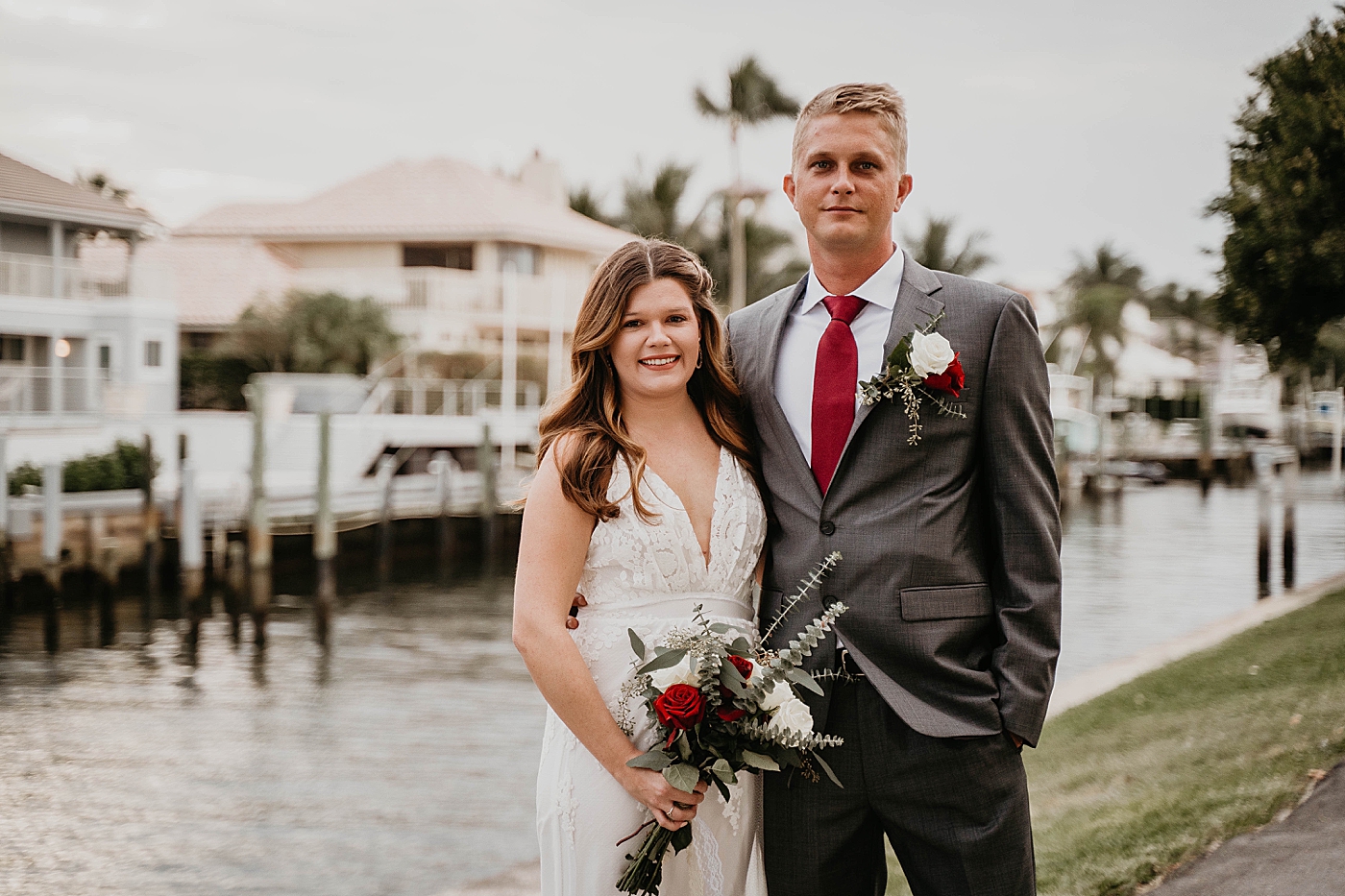 Bride and Groom portrait with red and white bouquet South Florida Elopement Photography captured by Krystal Capone Photography