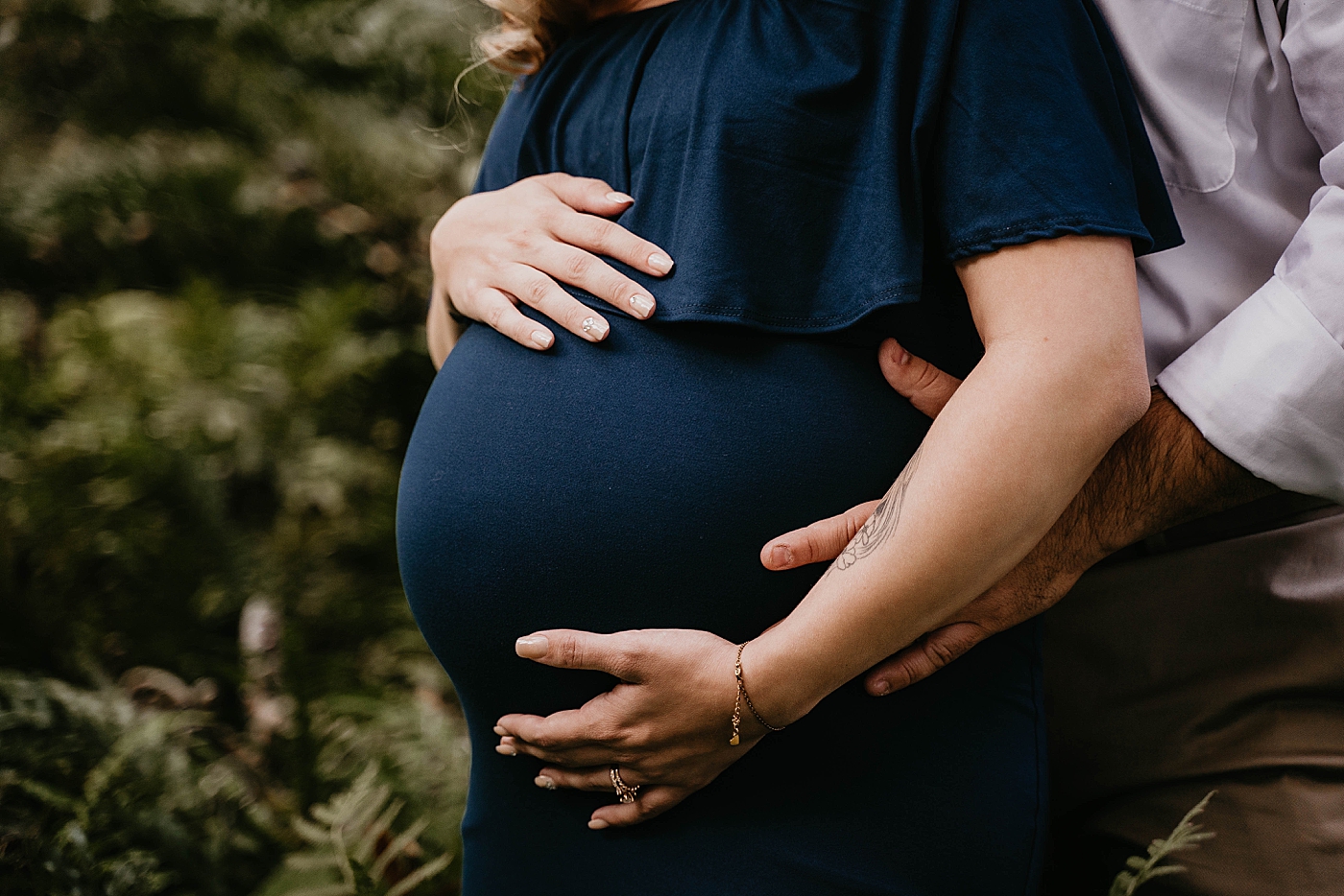 Husband and wife holding pregnant wife's stomach South Florida Maternity Photography captured by South Florida Family Photographer Krystal Capone Photography 