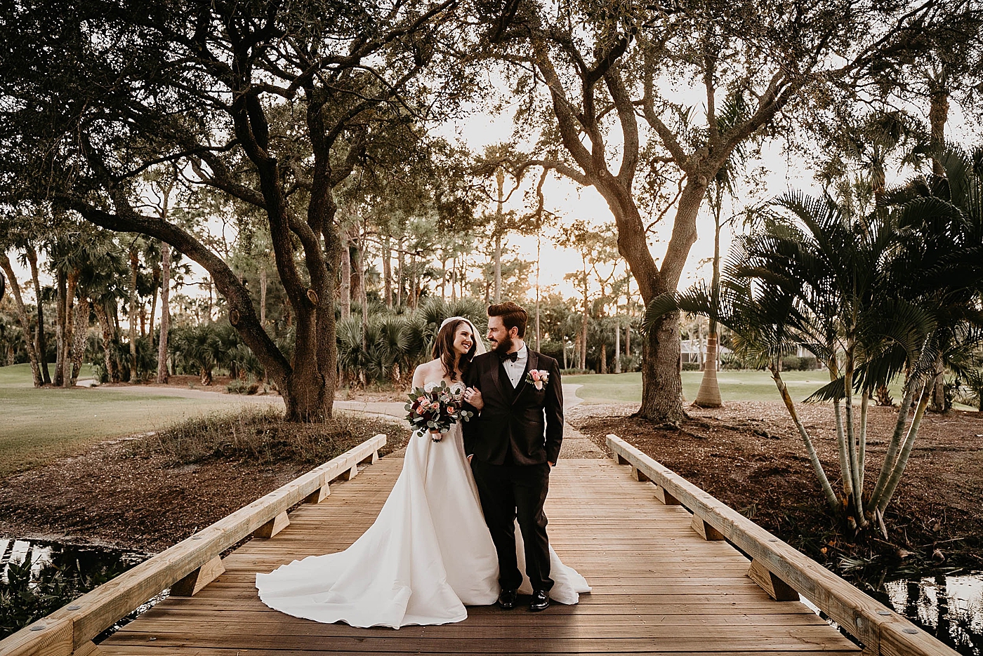 Bride and Groom with arms intertwined looking at each other on golf course Breakers West Wedding Photography captured by South Florida Wedding Photographer Krystal Capone Photography 