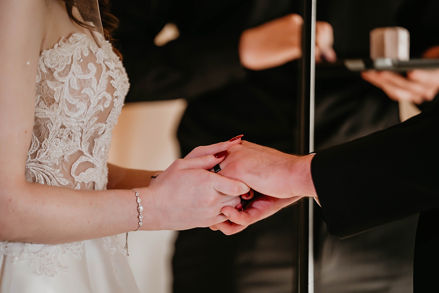 Closeup of Bride and Groom holding hands after putting on wedding bands Breakers West Wedding Photography captured by South Florida Wedding Photographer Krystal Capone Photography 