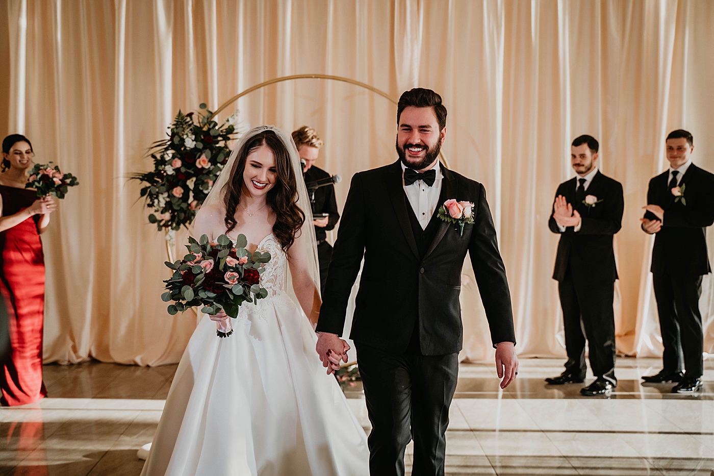 Bride and Groom holding hands exiting Ceremony Breakers West Wedding Photography captured by South Florida Wedding Photographer Krystal Capone Photography 