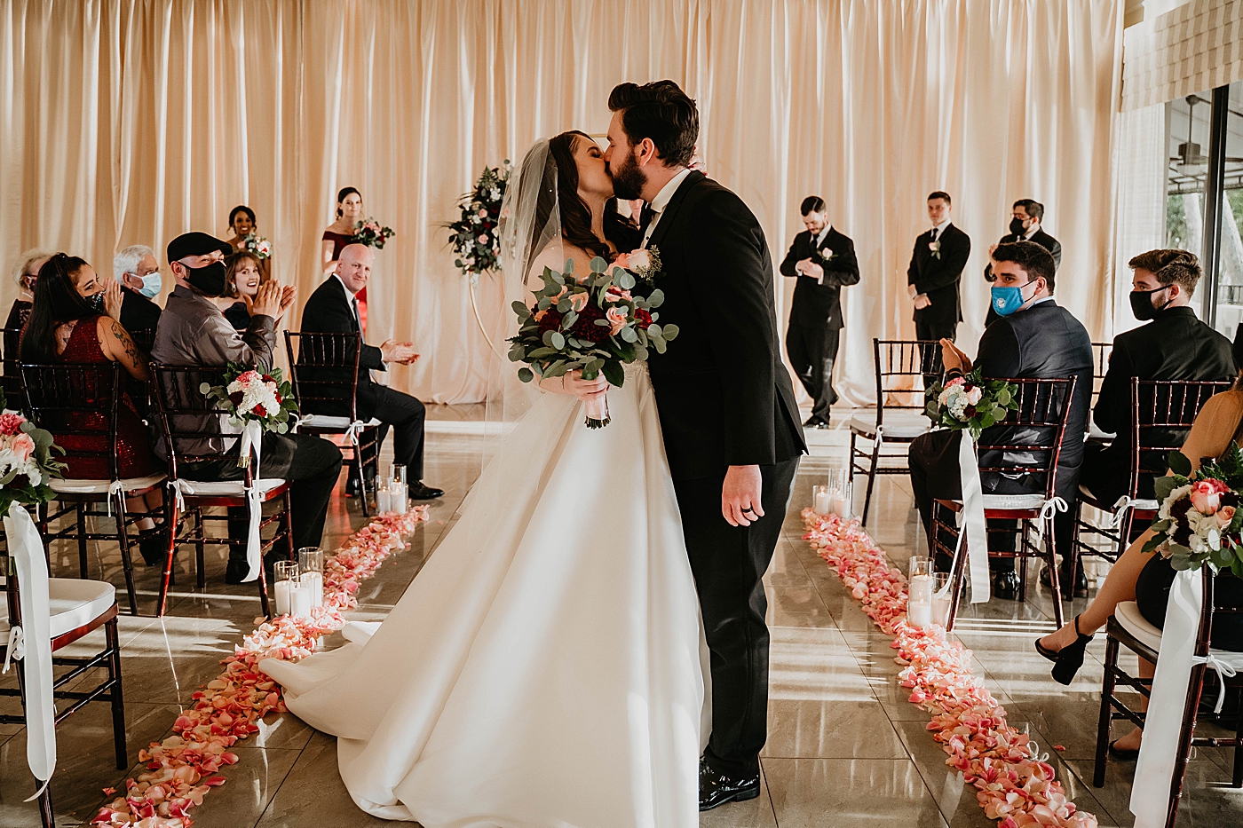Bride and Groom kissing as they exit Ceremony Breakers West Wedding Photography captured by South Florida Wedding Photographer Krystal Capone Photography 