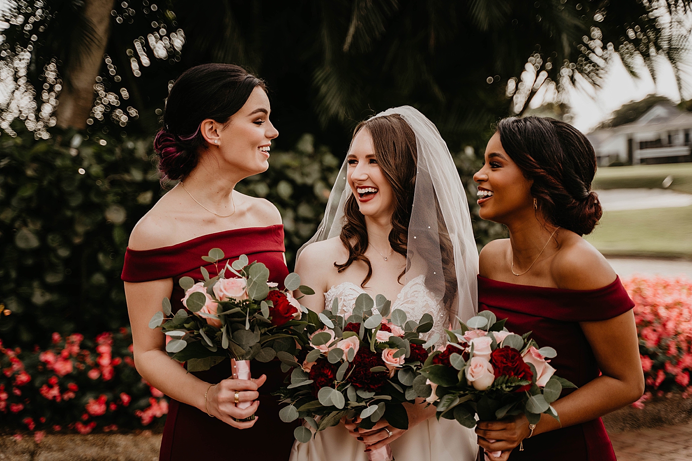Bride and Bridesmaids laughing with bouquets Breakers West Wedding Photography captured by South Florida Wedding Photographer Krystal Capone Photography 