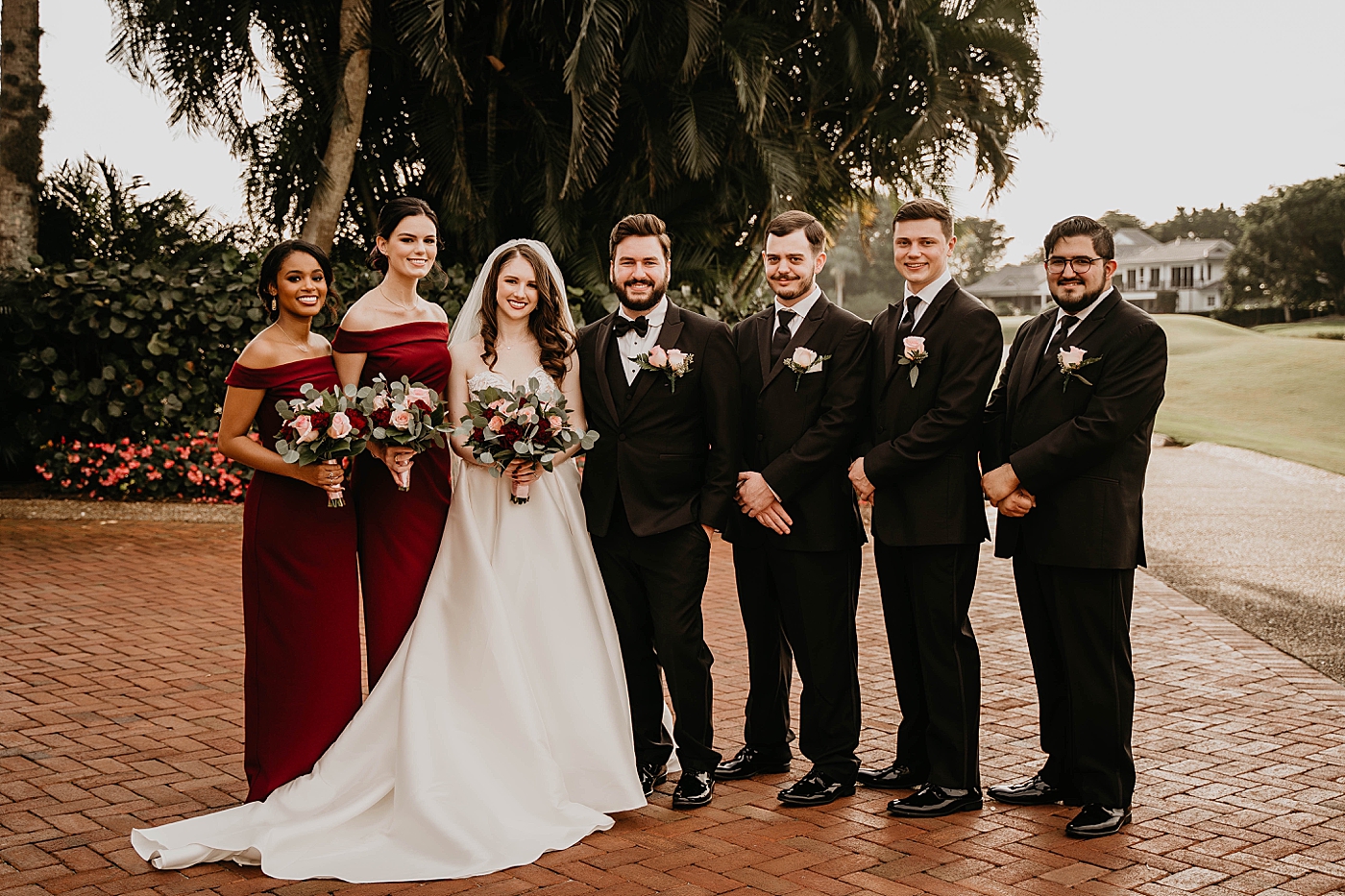 Bride and Groom with entire wedding party Breakers West Wedding Photography captured by South Florida Wedding Photographer Krystal Capone Photography 