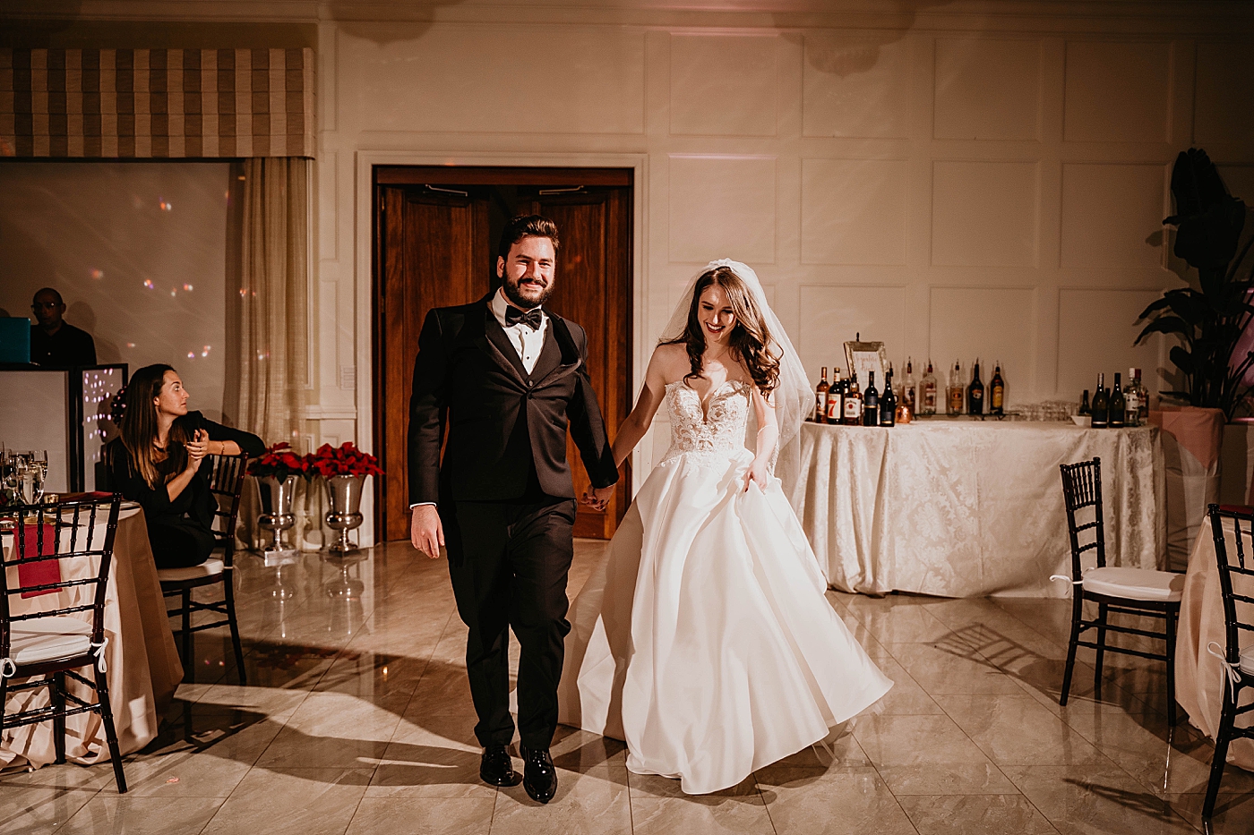 Bride and Groom entering Reception holding hands Breakers West Wedding Photography captured by South Florida Wedding Photographer Krystal Capone Photography 