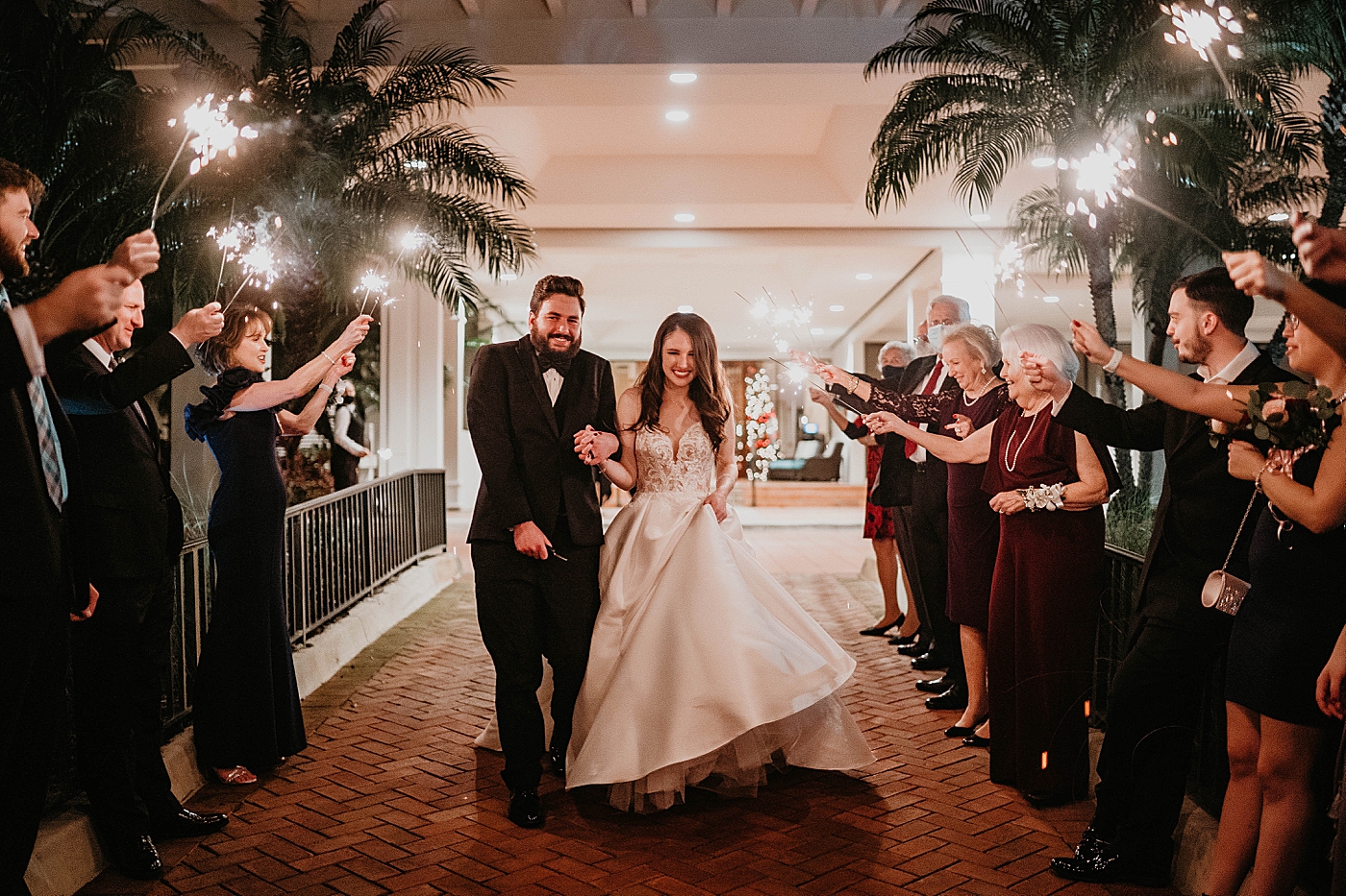 Bride and Groom sparkler exit nighttime Breakers West Wedding Photography captured by South Florida Wedding Photographer Krystal Capone Photography 