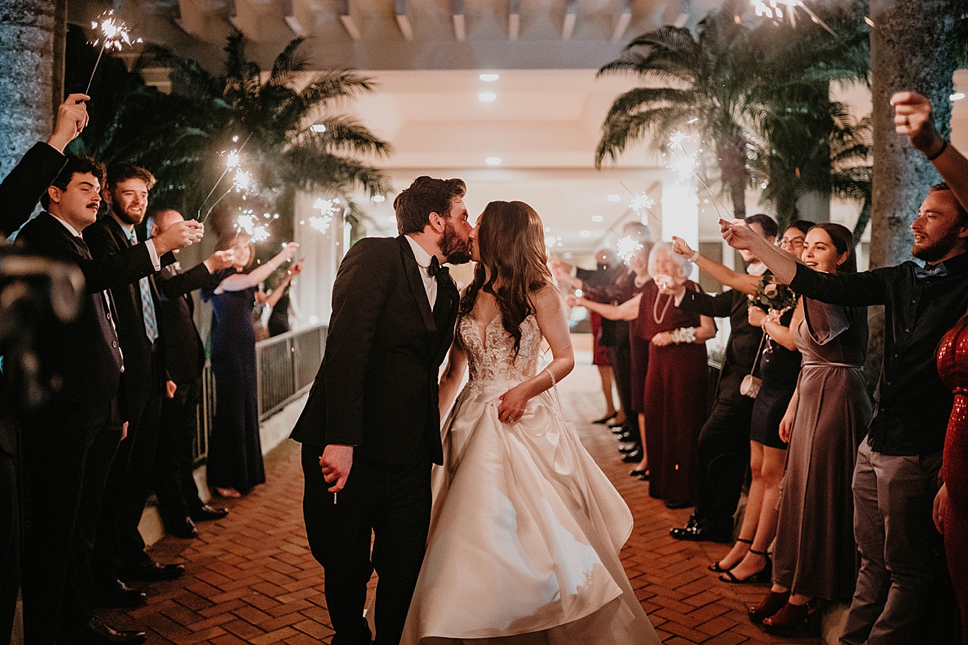 Bride and Groom kissing during sparkler exit Breakers West Wedding Photography captured by South Florida Wedding Photographer Krystal Capone Photography 