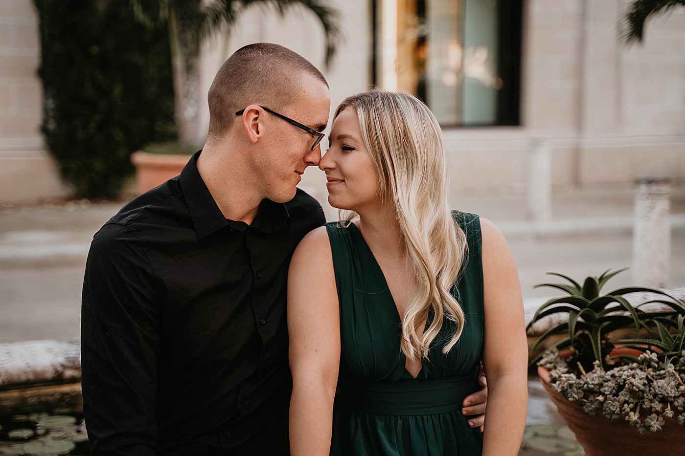 Couple nuzzling in front of mansion Worth Ave Engagement Photography captured by Engagement Photographer Krystal Capone Photography