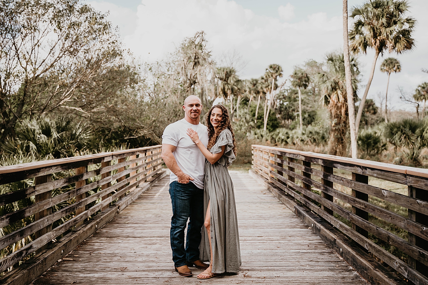 Couple holding each other on wooden bridge Romantic Riverbend Park Engagement Photography captured by South Florida Photographer Krystal Capone Photography