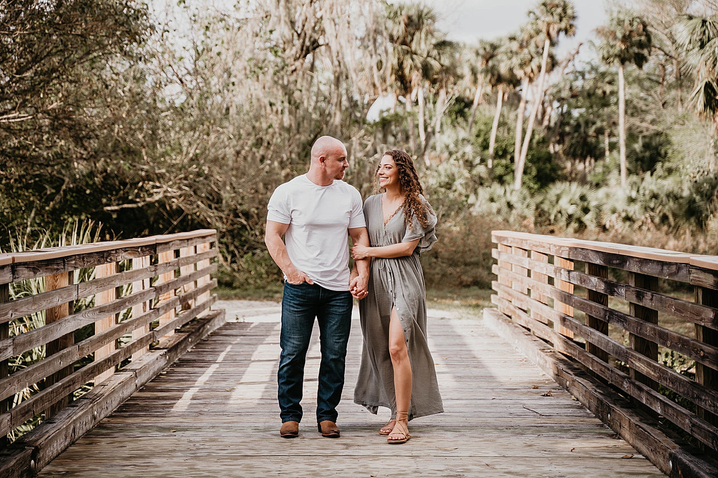 Couple walking together with woman holding man's arm Romantic Riverbend Park Engagement Photography captured by South Florida Photographer Krystal Capone Photography