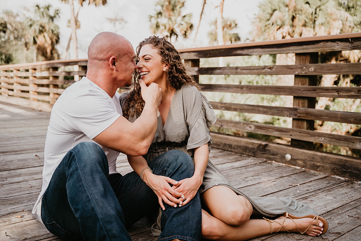 Couple sitting next to each other as they are about to kiss Romantic Riverbend Park Engagement Photography captured by South Florida Photographer Krystal Capone Photography