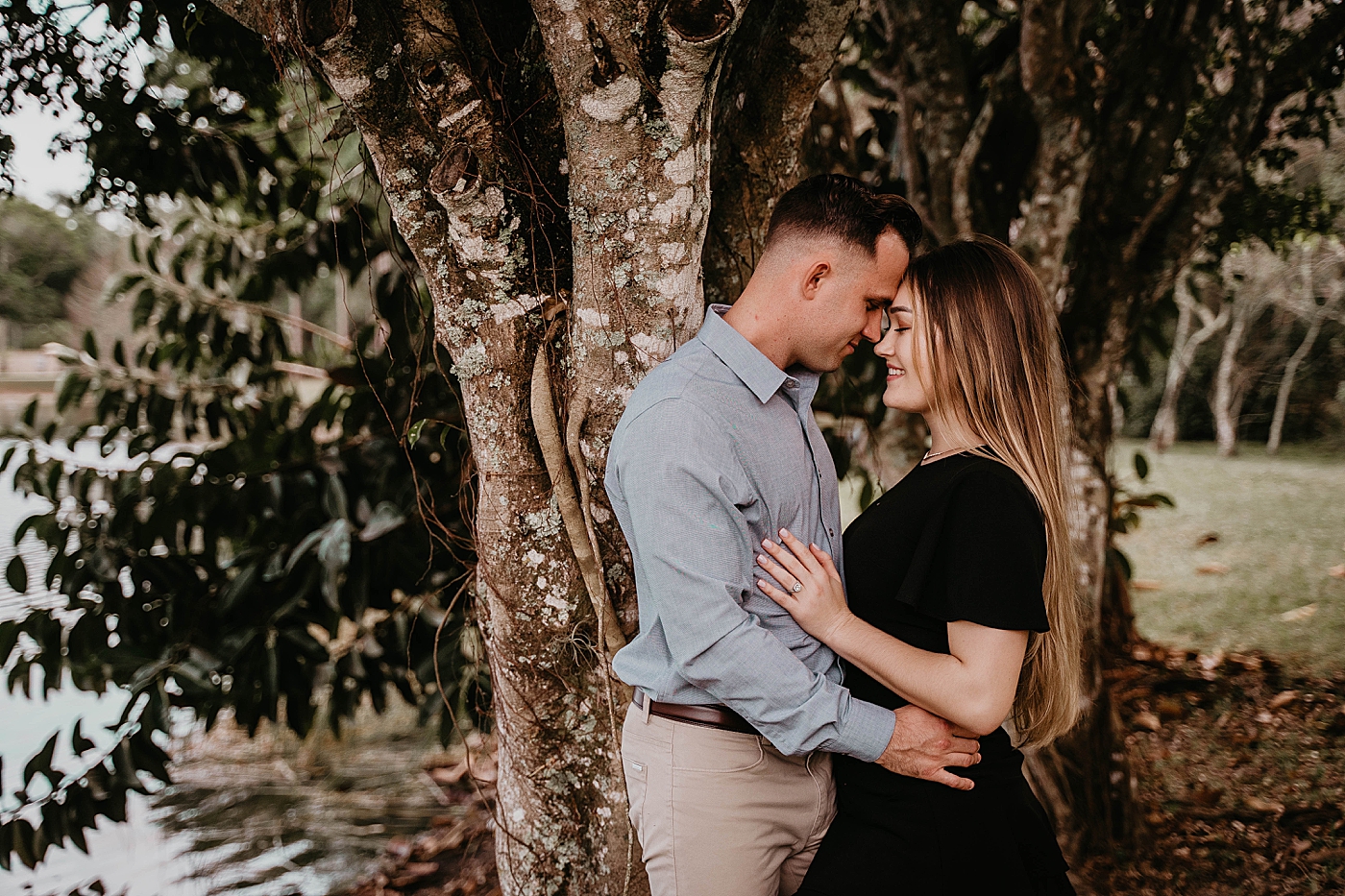 Couple holding each other next to a tree Rustic South Florida Engagement Photography captured by South Florida Engagement Photographer Krystal Capone Photography 
