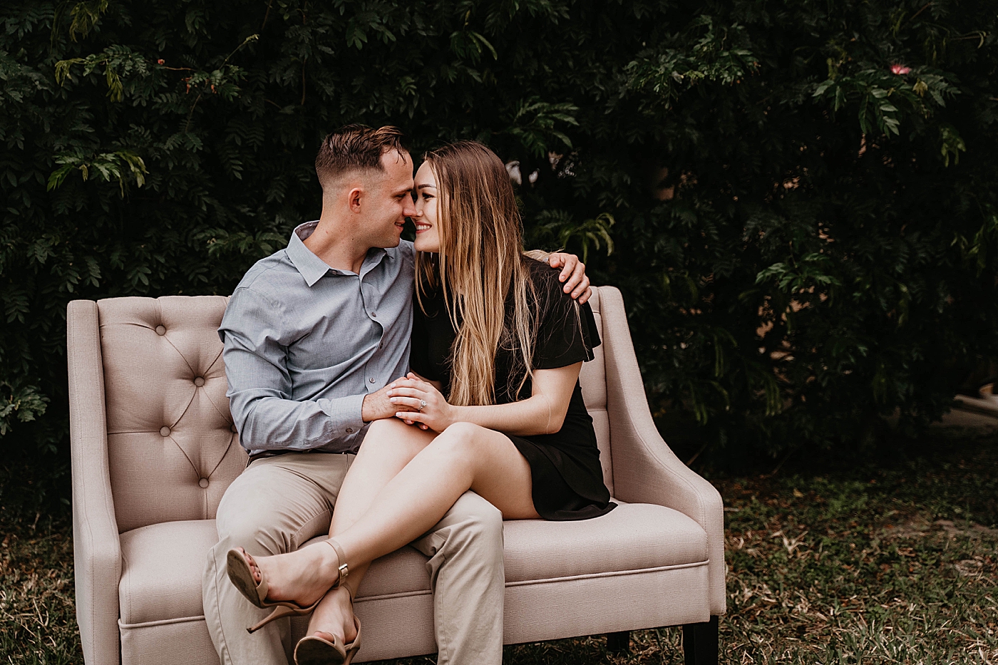 Couple sitting on setee holding each other about to kiss Rustic South Florida Engagement Photography captured by South Florida Engagement Photographer Krystal Capone Photography 