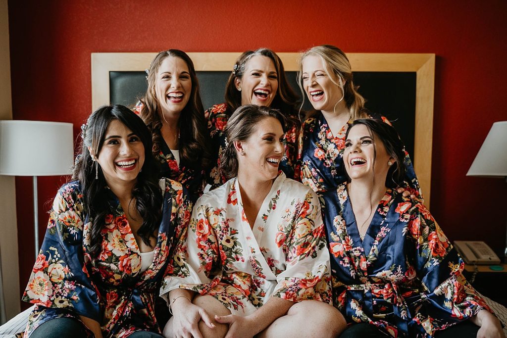 Bride and Bridesmaids about to get ready with floral silk robes on 94th Aero Squadron Miami Wedding Photography captured by South Florida Engagement Photographer Krystal Capone Photography 