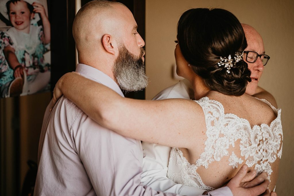 Bride hugging family 94th Aero Squadron Miami Wedding Photography captured by South Florida Engagement Photographer Krystal Capone Photography 