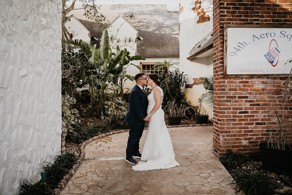 Bride and Groom kissing in courtyard 94th Aero Squadron Miami Wedding Photography captured by South Florida Engagement Photographer Krystal Capone Photography 