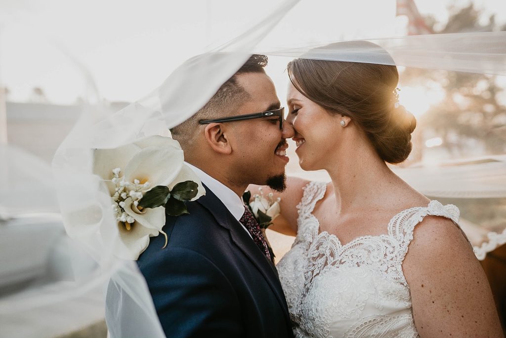 Bride and Groom about to kiss under the veil 94th Aero Squadron Miami Wedding Photography captured by South Florida Engagement Photographer Krystal Capone Photography 