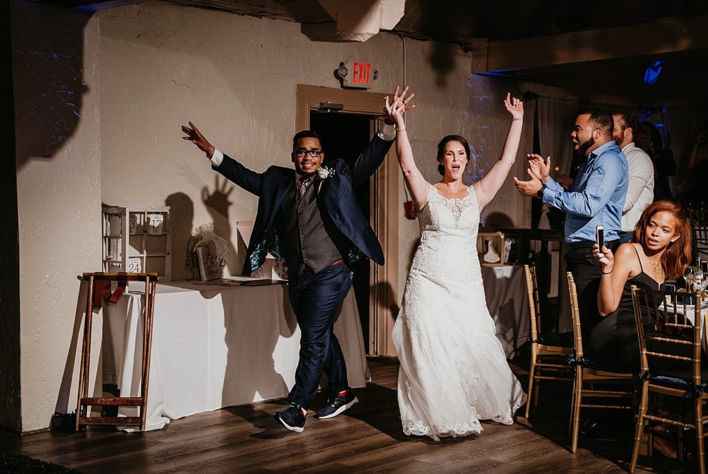 Bride and Groom entering Reception with hands in the air 94th Aero Squadron Miami Wedding Photography captured by South Florida Engagement Photographer Krystal Capone Photography 
