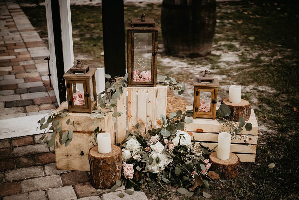 Detail shot of Wedding decor with lamps with pink flowers in them and candles Ever After Farms Wedding Photography captured by South Florida Wedding Photographer Krystal Capone Photography 