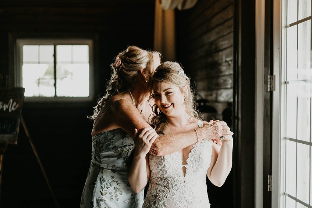 Mother hugging Bride after Getting ready Ever After Farms Wedding Photography captured by South Florida Wedding Photographer Krystal Capone Photography 