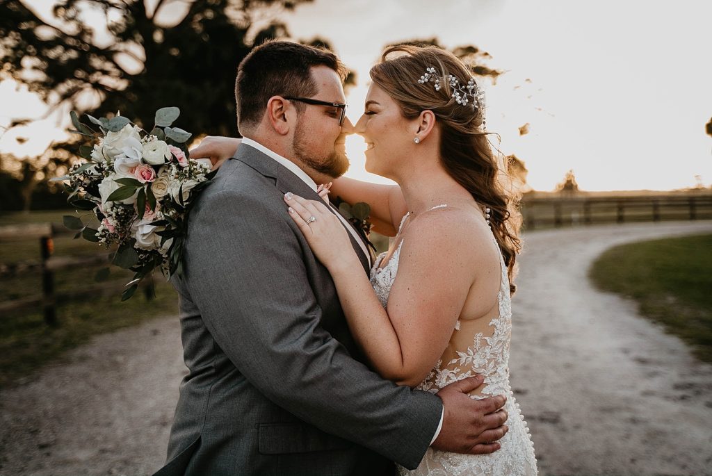 Bride and Groom holding each other and touching their noses Ever After Farms Wedding Photography captured by South Florida Wedding Photographer Krystal Capone Photography 