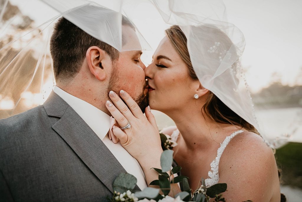 Bride and Groom kissing under the veil Ever After Farms Wedding Photography captured by South Florida Wedding Photographer Krystal Capone Photography 